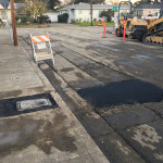 temporary asphalt patches on street and sidewalk